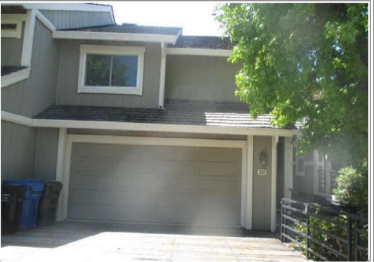 a house with a garage door in front of it