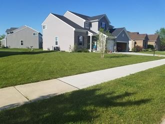 a house with a sidewalk in front of it