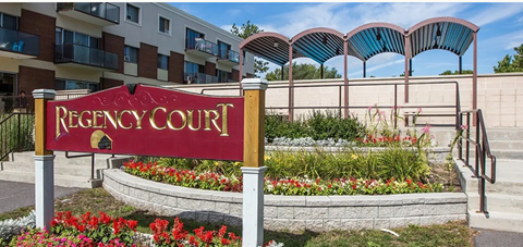 a sign for the registry court in front of an apartment building