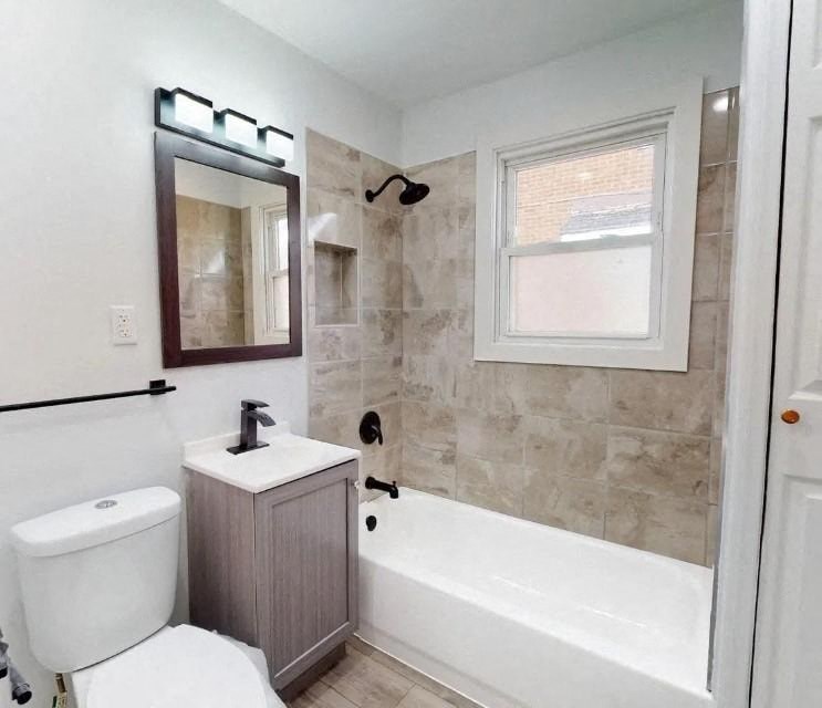 a bathroom with a toilet and a tub and a sink