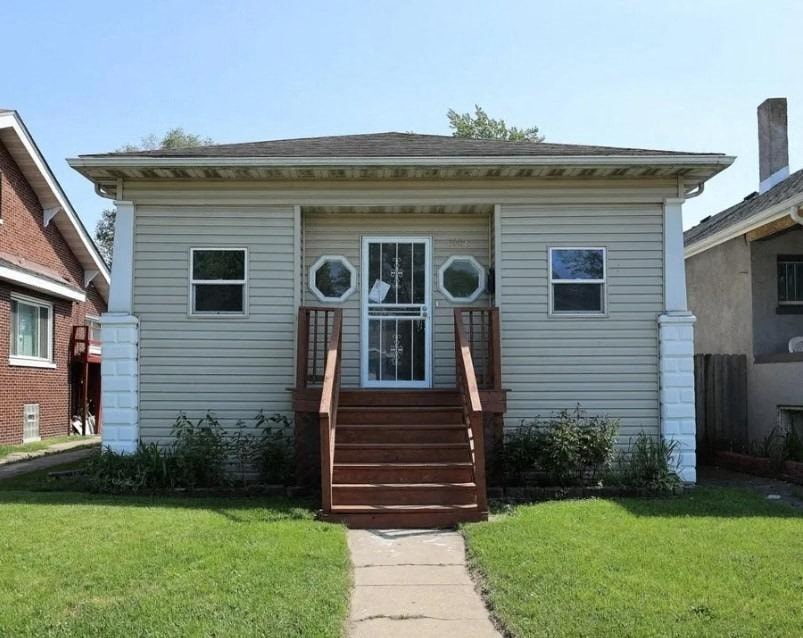 a white house with stairs and a front door