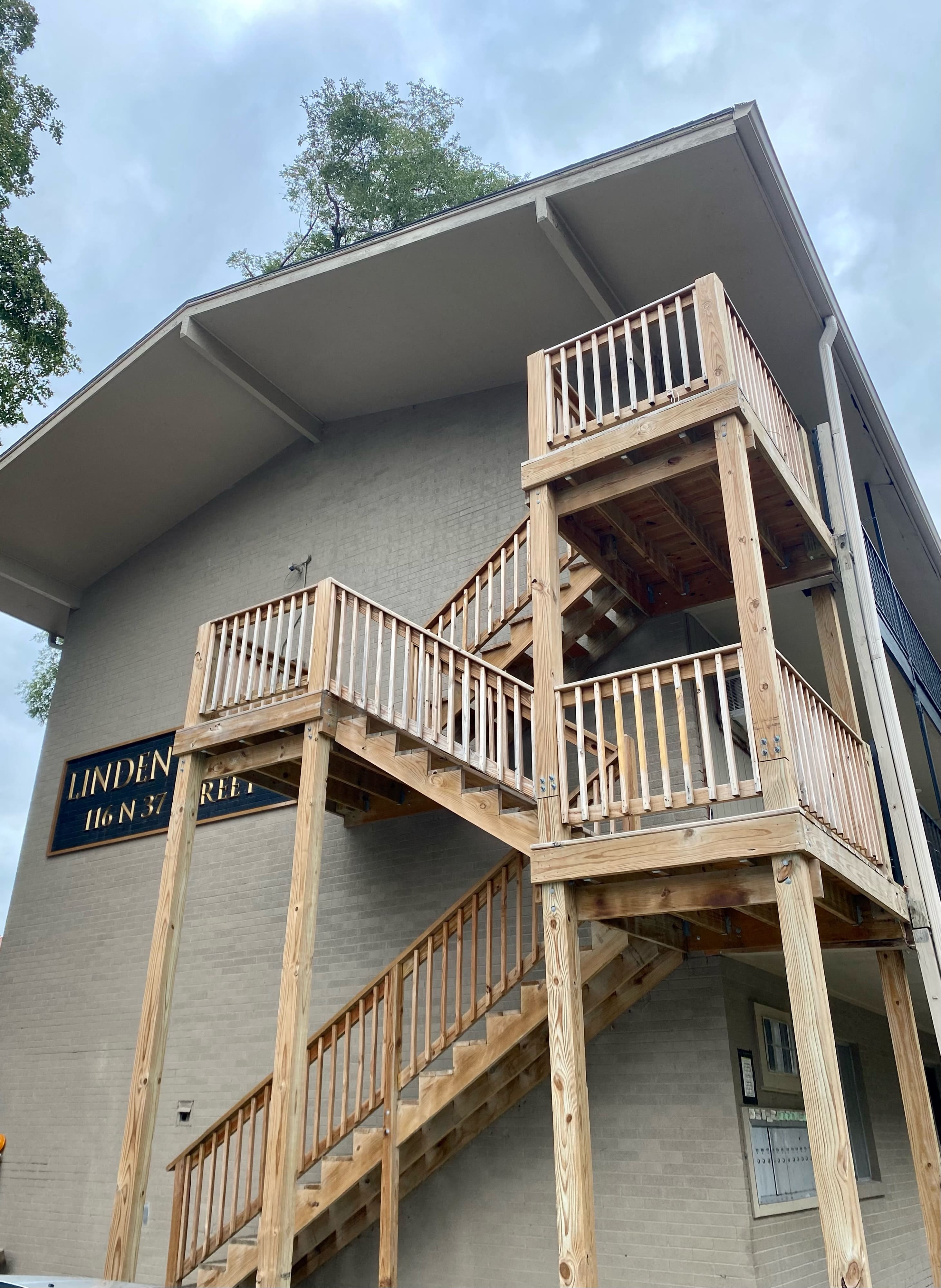 a building with wooden stairs on the side of it