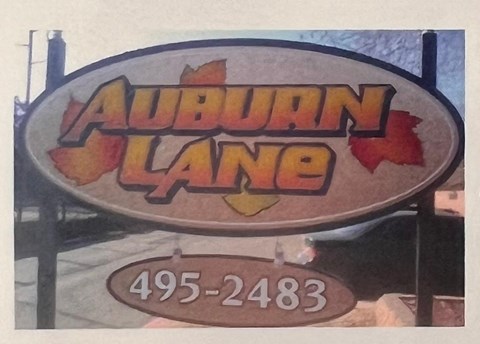 A sign that says Auburn Lane with a phone number underneath it.