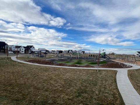 A park with a playground and a walking path.