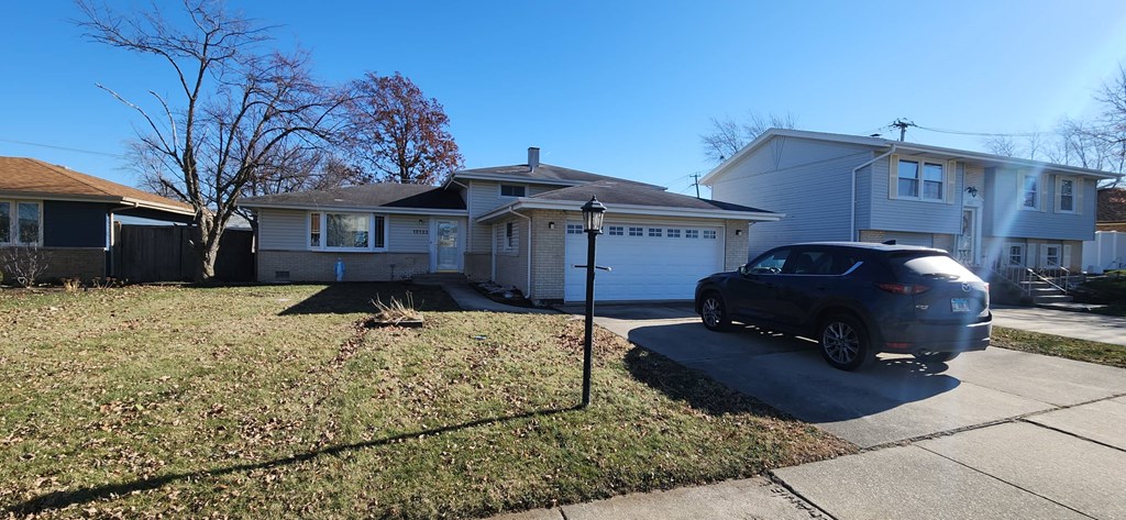 a house with a car parked in the driveway