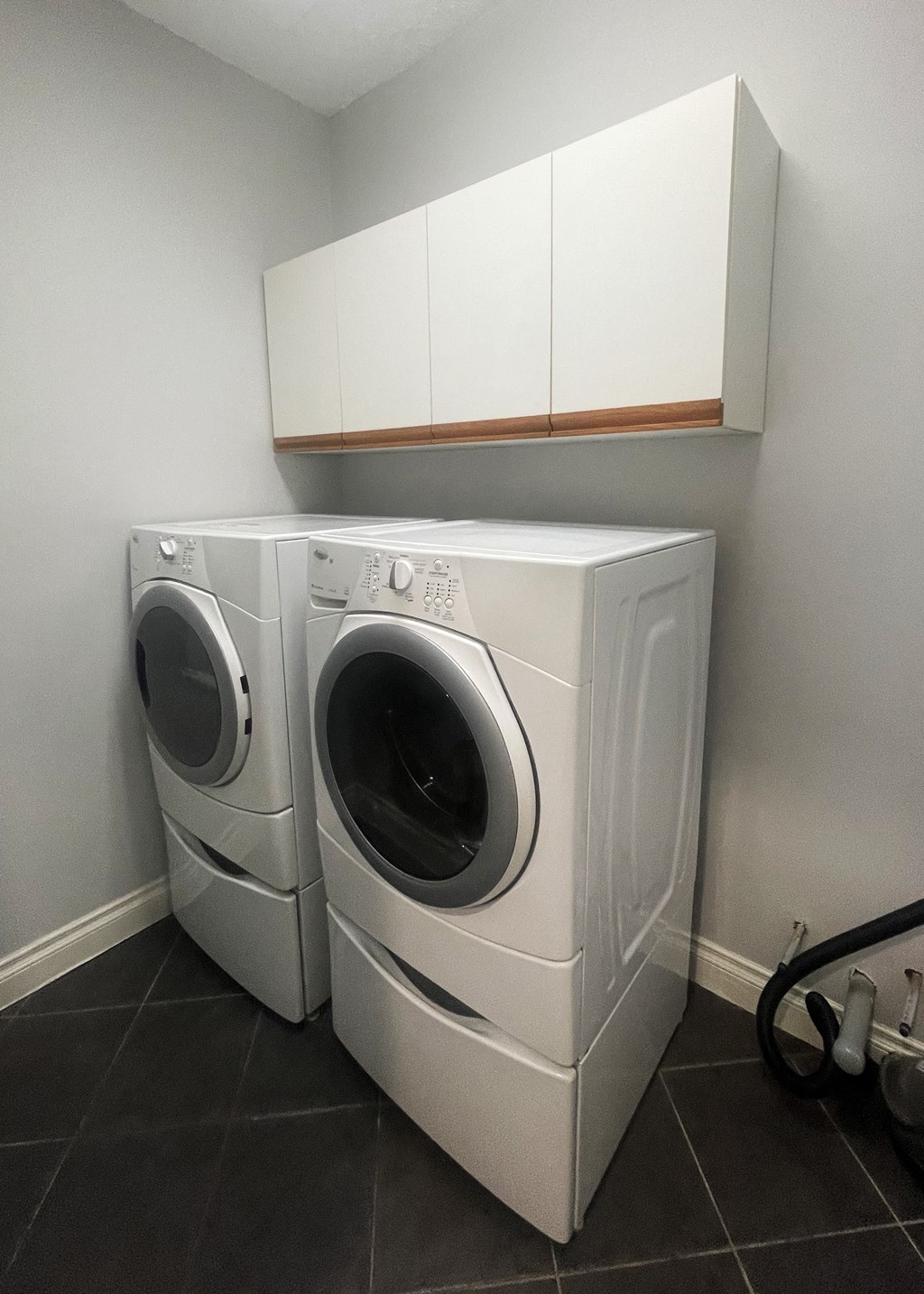 a washing machine and a dryer in a laundry room