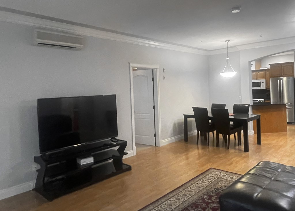 an image of a living room with a tv and a dining room