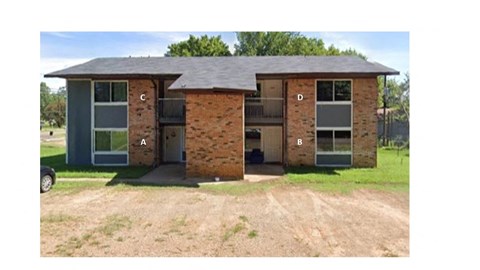 a brick house with a car parked in front of it