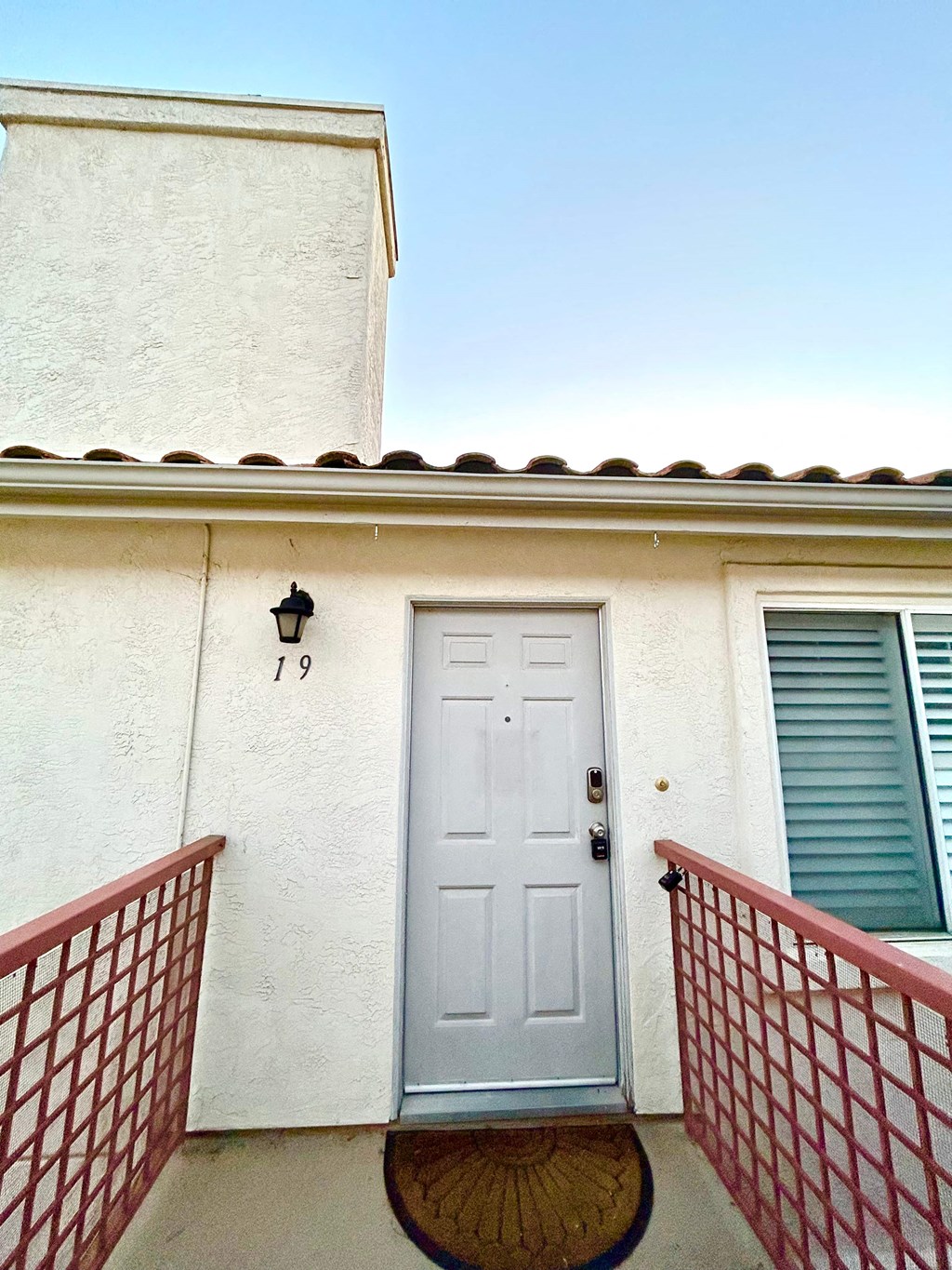 a white house with a white door and a balcony