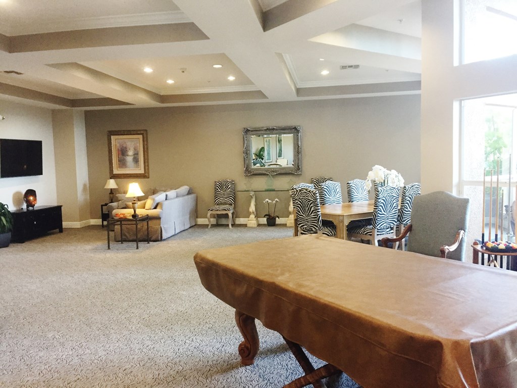 a large living room with a large table and chairs