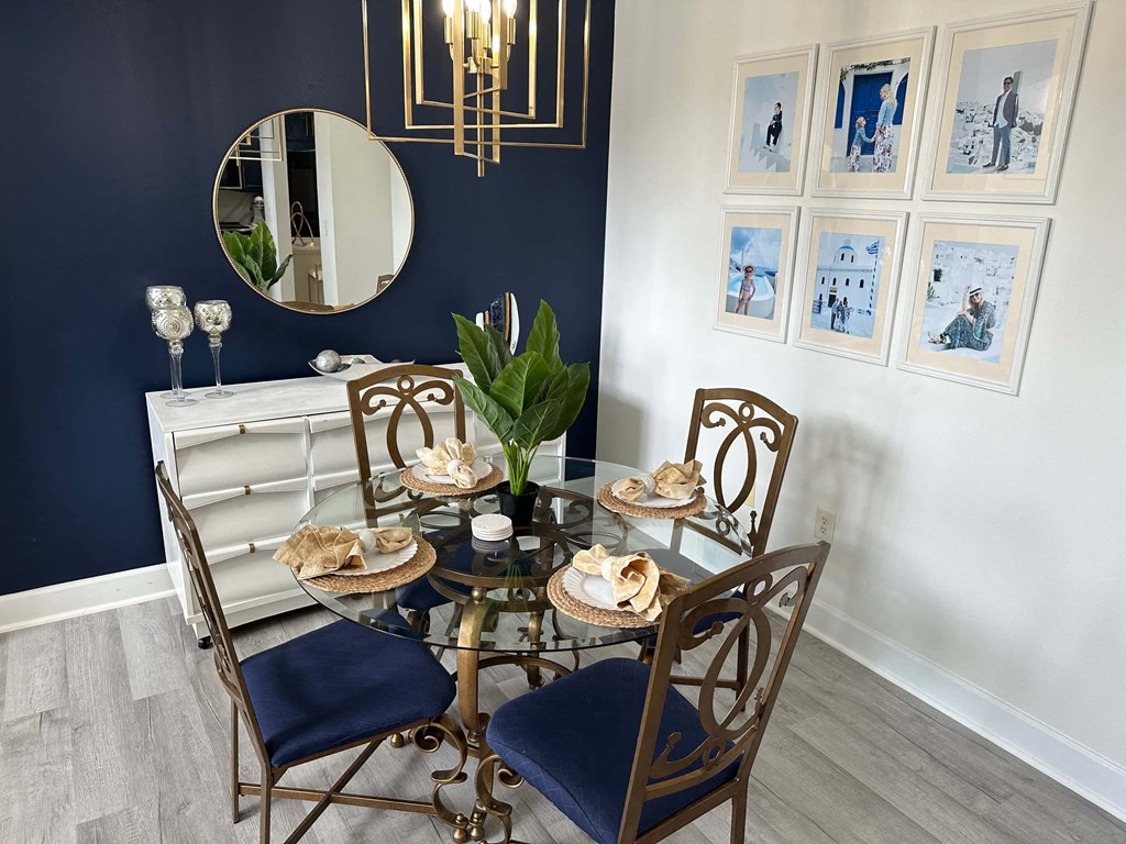 a dining room with a table and chairs and a mirror