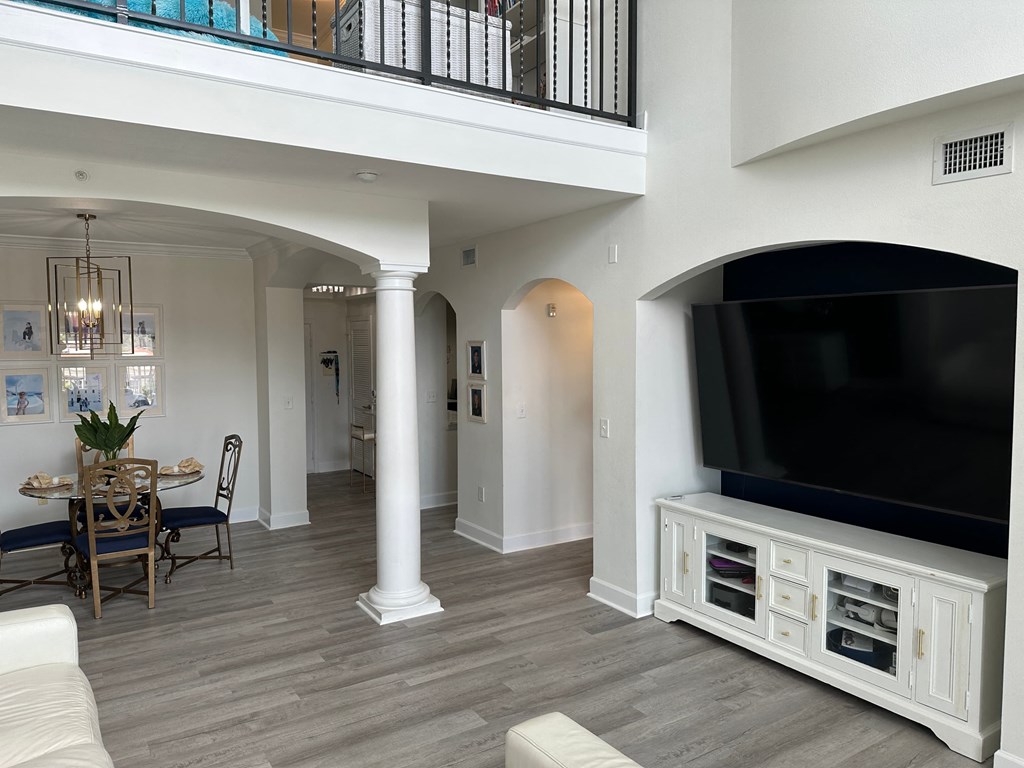 a living room with a tv and a dining room