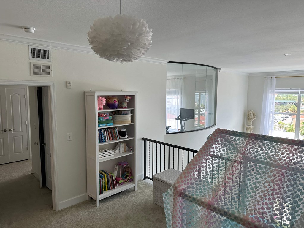 a bedroom with a bed and a dresser and a mirror