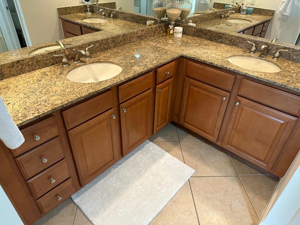 a bathroom with two sinks and a marble counter top