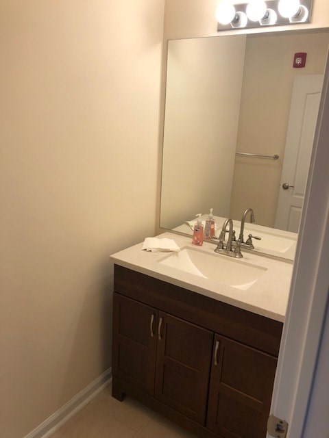 A bathroom with a sink and a mirror.