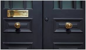 a black door with a gold door handle