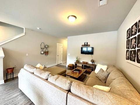 a living room with a couch and a tv