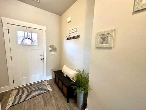 a foyer with a white door and a window