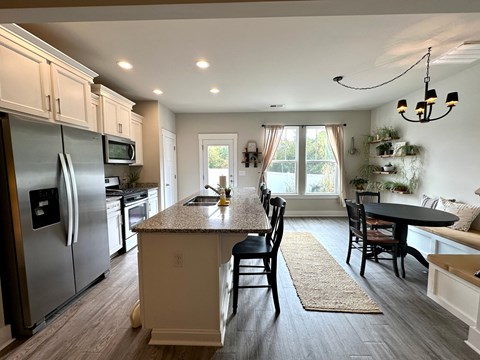 a kitchen with a center island and stainless steel appliances