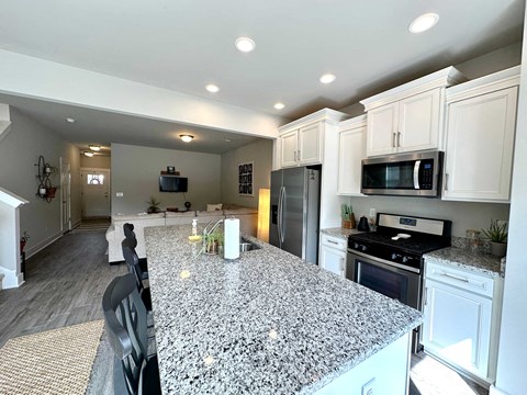 a kitchen with a large granite counter top