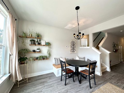 a dining room with a table and chairs and a window