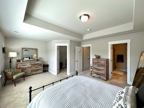 a master bedroom with a large bed and a closet
