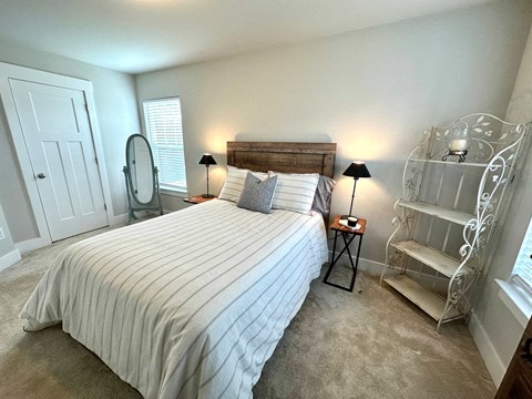 a bedroom with a bed and a dresser with a mirror