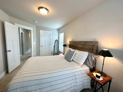 a bedroom with a large bed and a closet