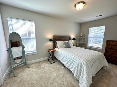 a bedroom with a bed and a mirror