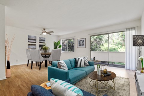 A living room with a blue couch and a coffee table.