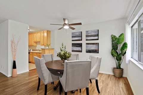 A dining room with a table and chairs.