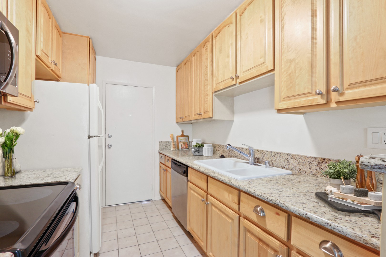 A kitchen with wooden cabinets and a white refrigerator.