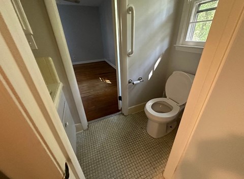 a small bathroom with a toilet and a window