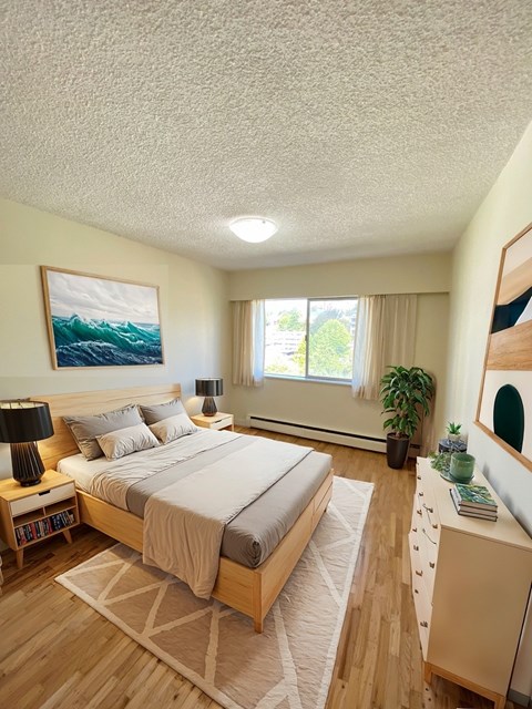 A bedroom with a large bed and a painting on the wall.