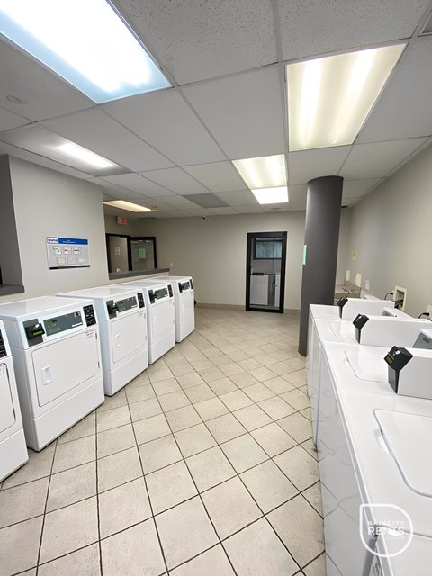 A laundromat with rows of washers and dryers.