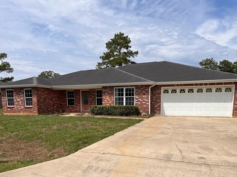 a brick house with a white garage door