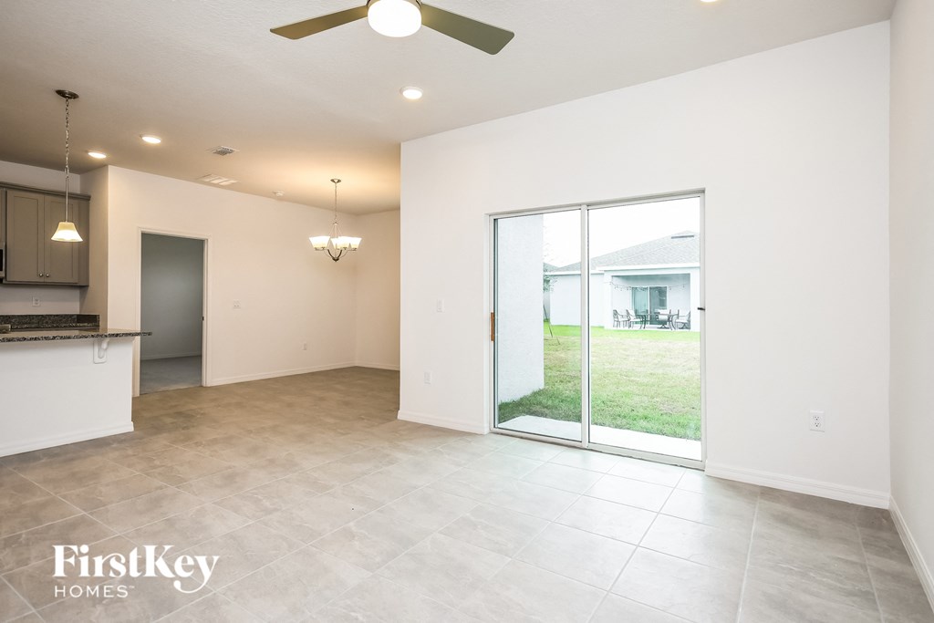 an empty living room with a sliding glass door to the yard