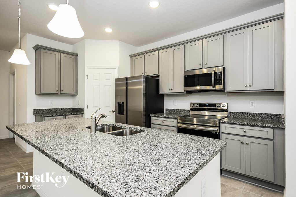 a kitchen with granite counter tops and stainless steel appliances