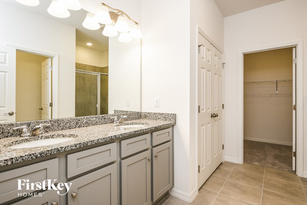 a bathroom with two sinks and a large mirror