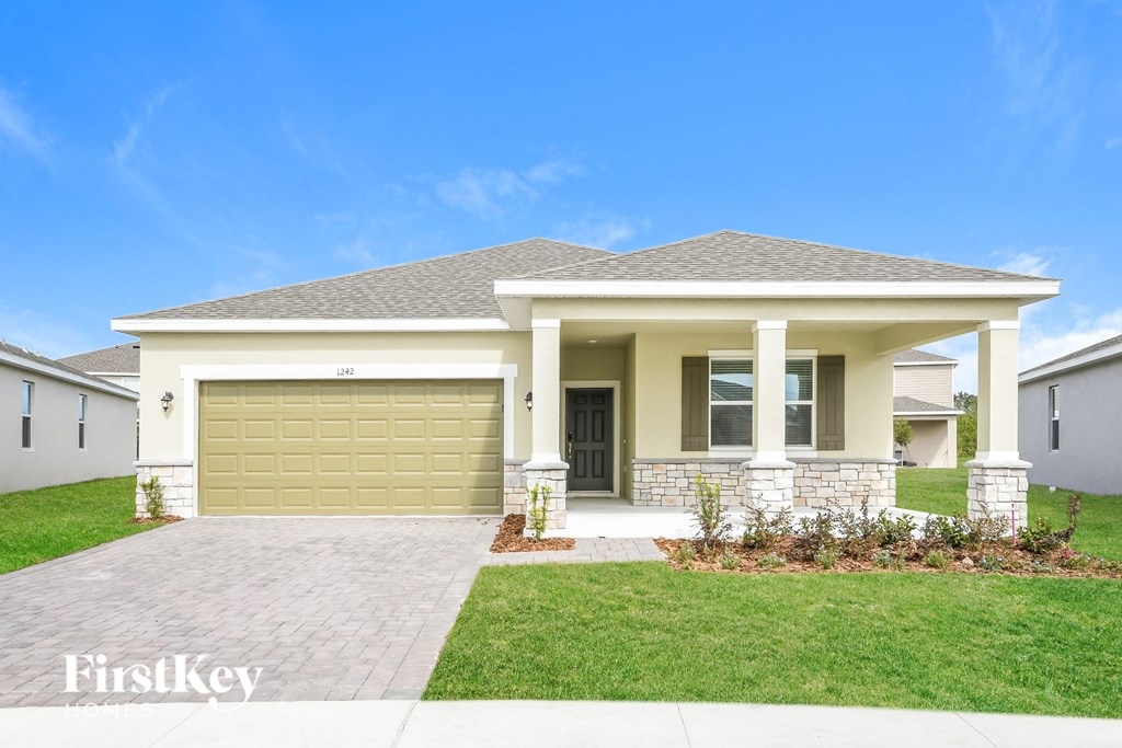 A house with a garage door and a front door is shown.