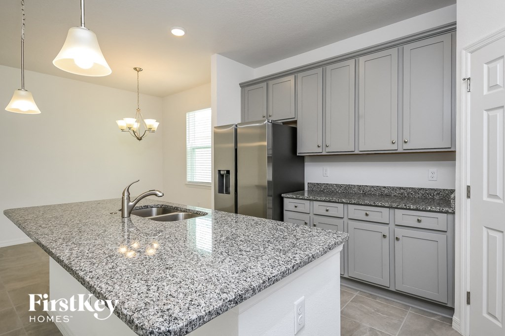 A kitchen with granite countertops and a sink.