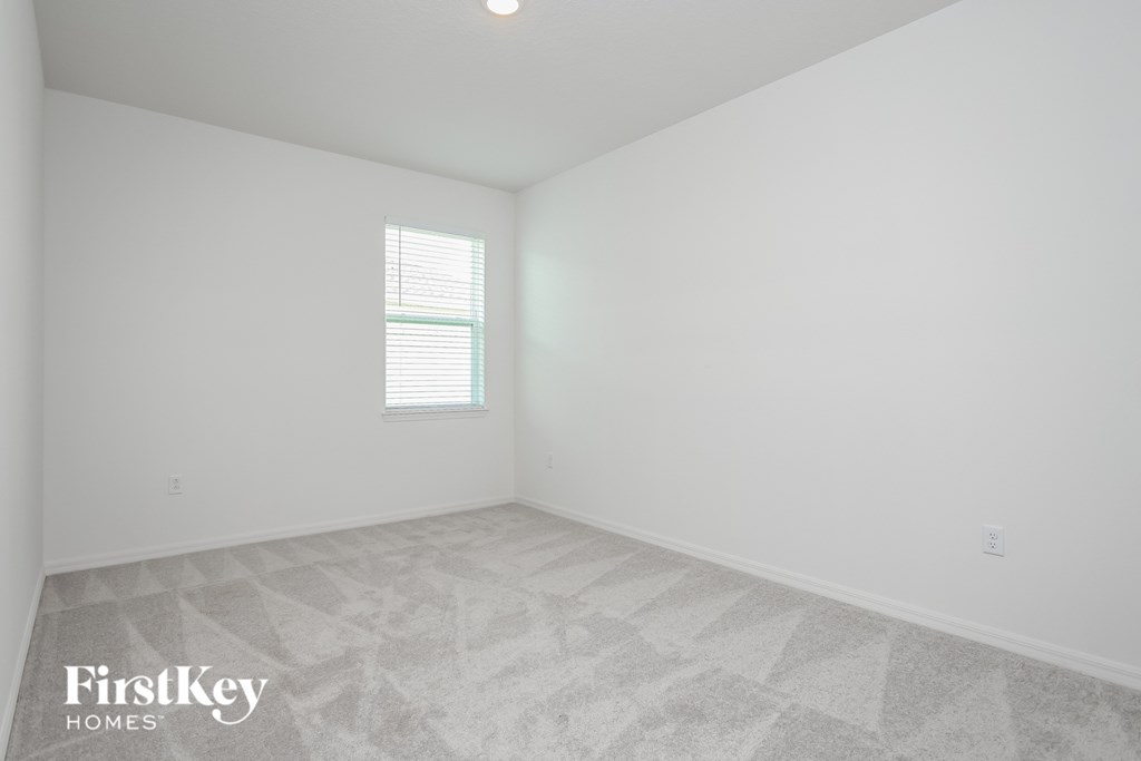 A room with a FirstKey Homes logo on the floor.