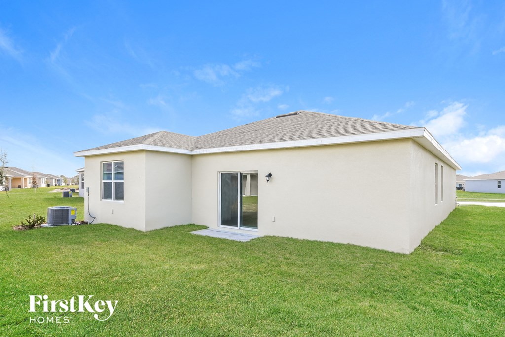 A small white house with a brown roof and a glass door is shown.