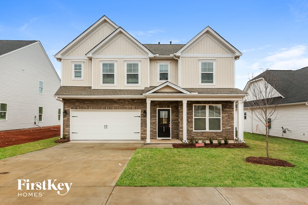 a house with a white garage door and a lawn