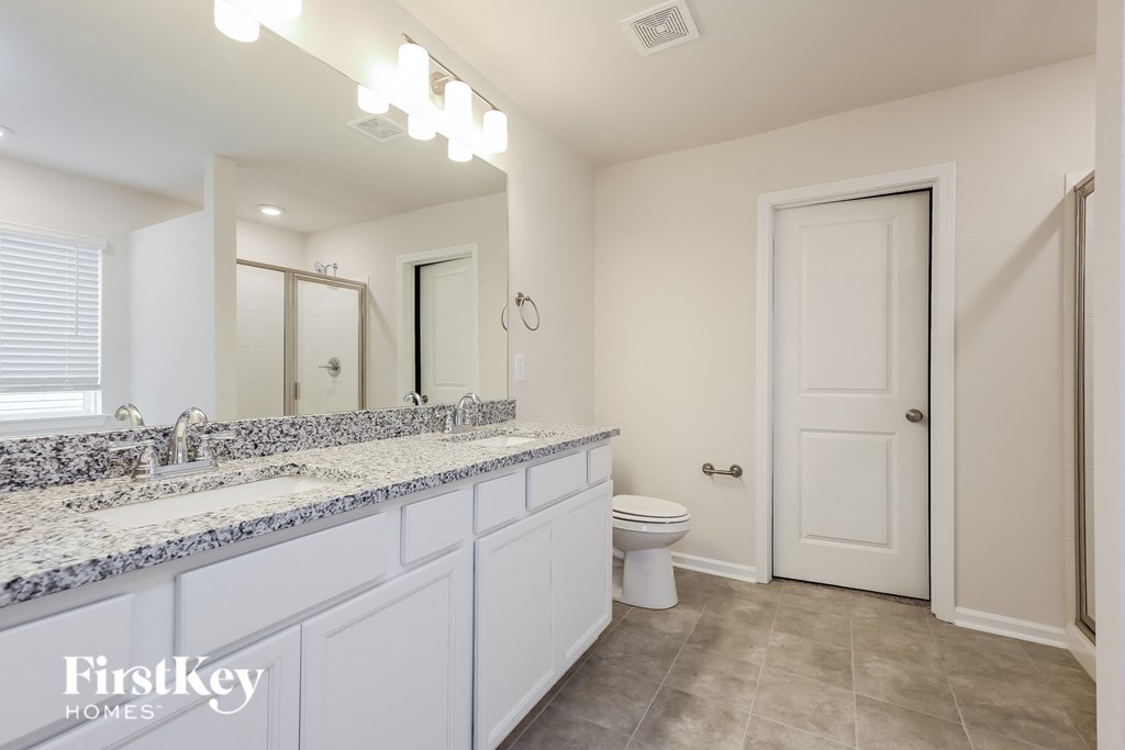 a bathroom with a toilet and a sink and a mirror