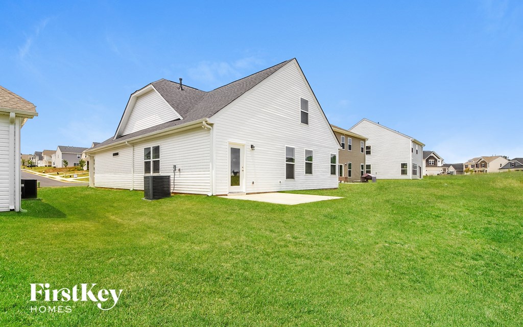 a white house with a yard in front of it