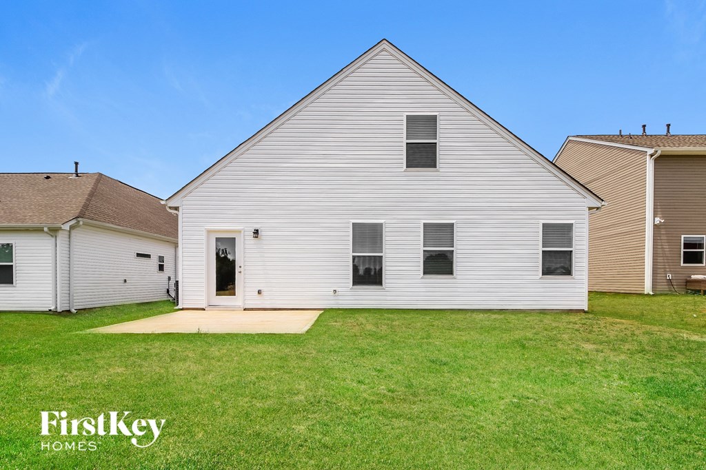 a white house with a yard in front of it
