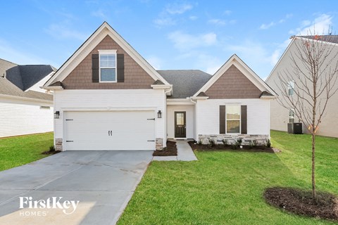 A house with a brown roof and a white garage door.