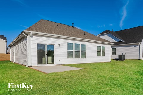 A house with a brown roof and a white exterior is shown with the words "FirstKey Homes" on the bottom left.