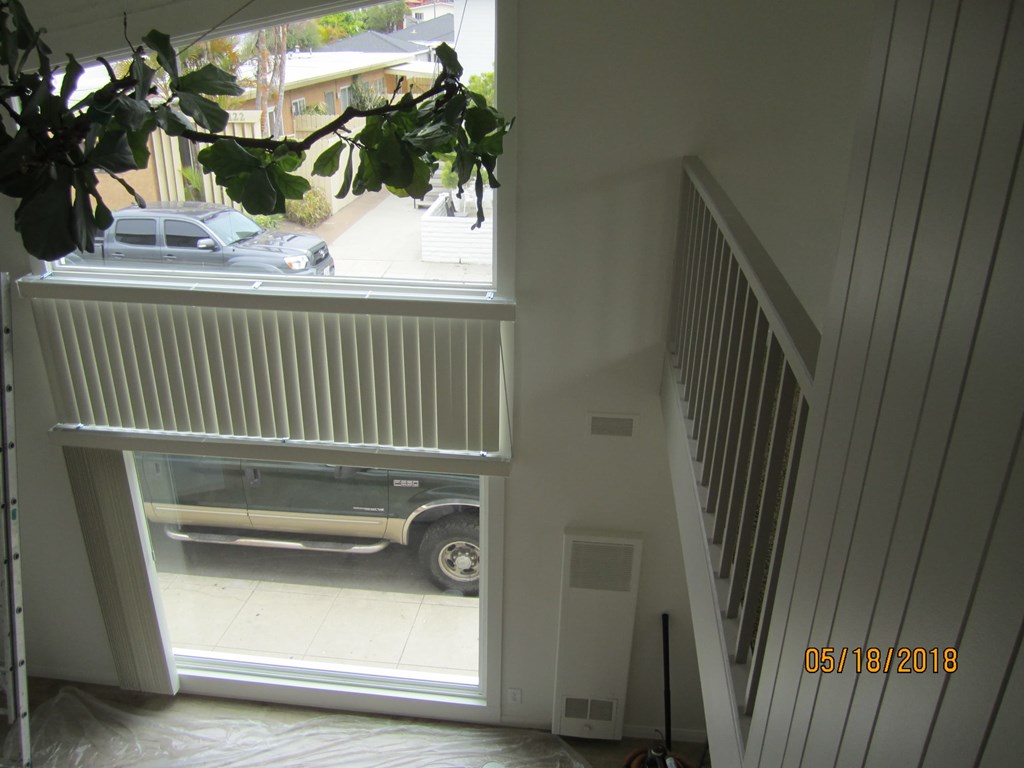 A car is parked in a driveway outside a house.